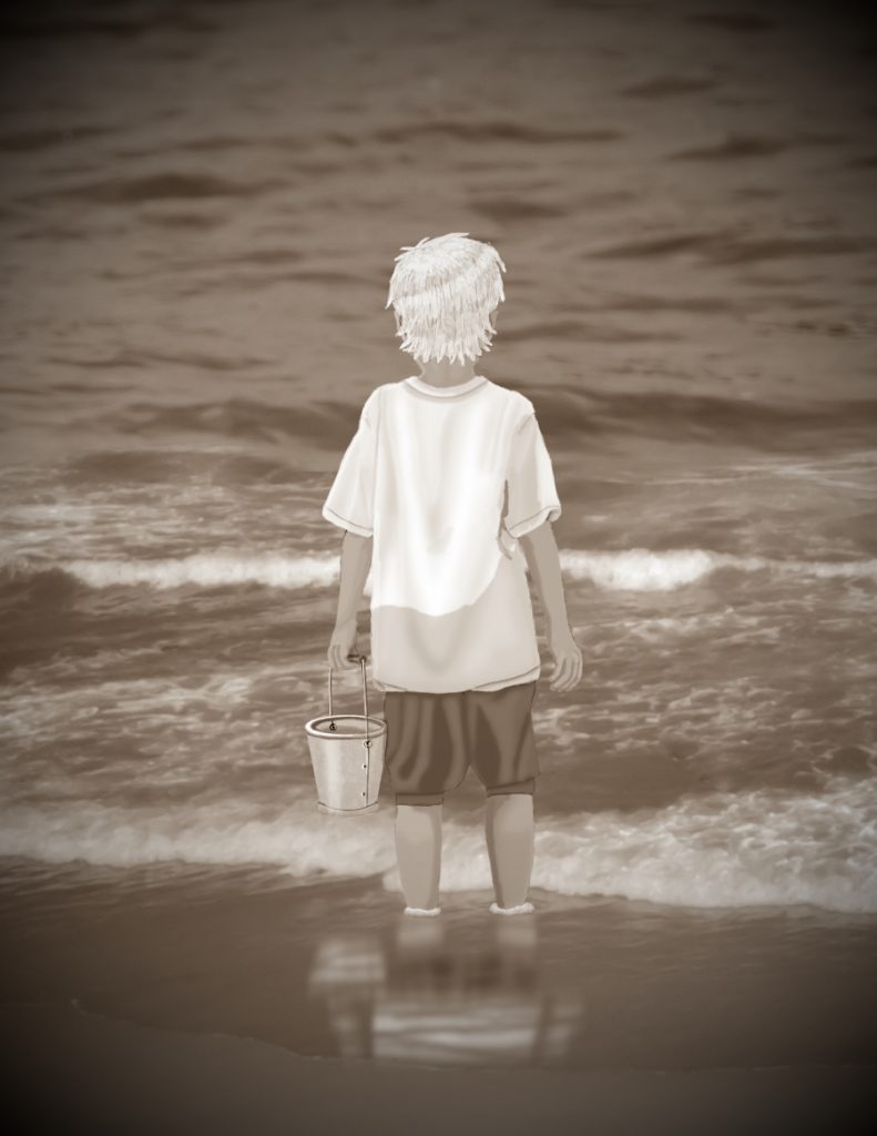 Erik standing in front of the ocean, with a bucket.